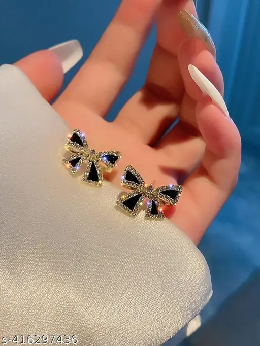 Golden and black-colored bow-shaped studs