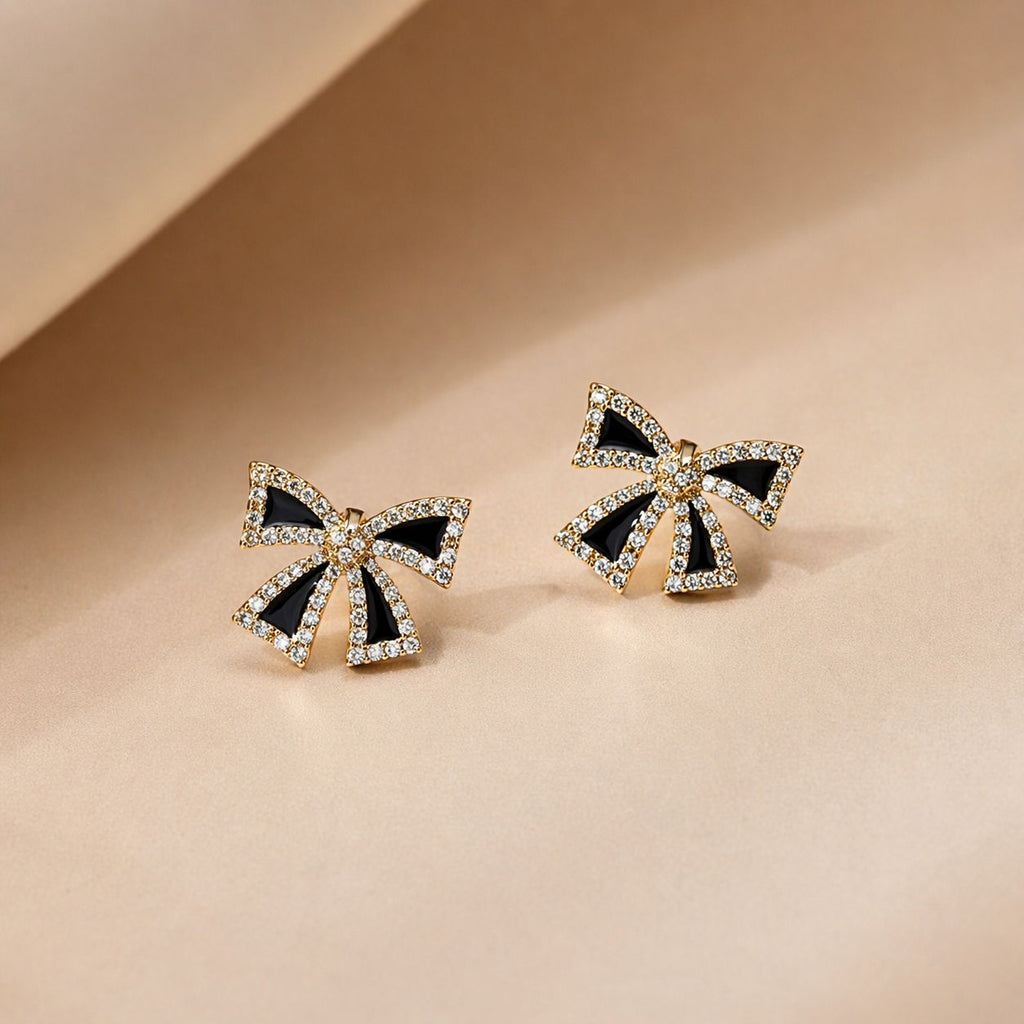 Golden and black-colored bow-shaped studs