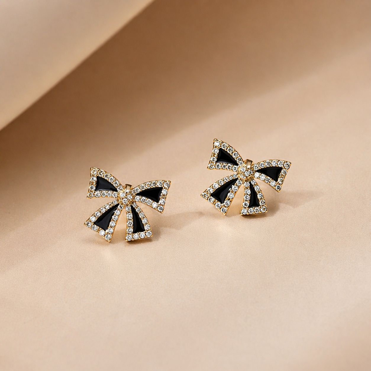 Golden and black-colored bow-shaped studs